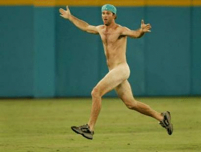 A streaker runs across the field after the seventh inning in Game 5 of the World Series in Miami October 23, 2003. REUTERS/Mike Blake